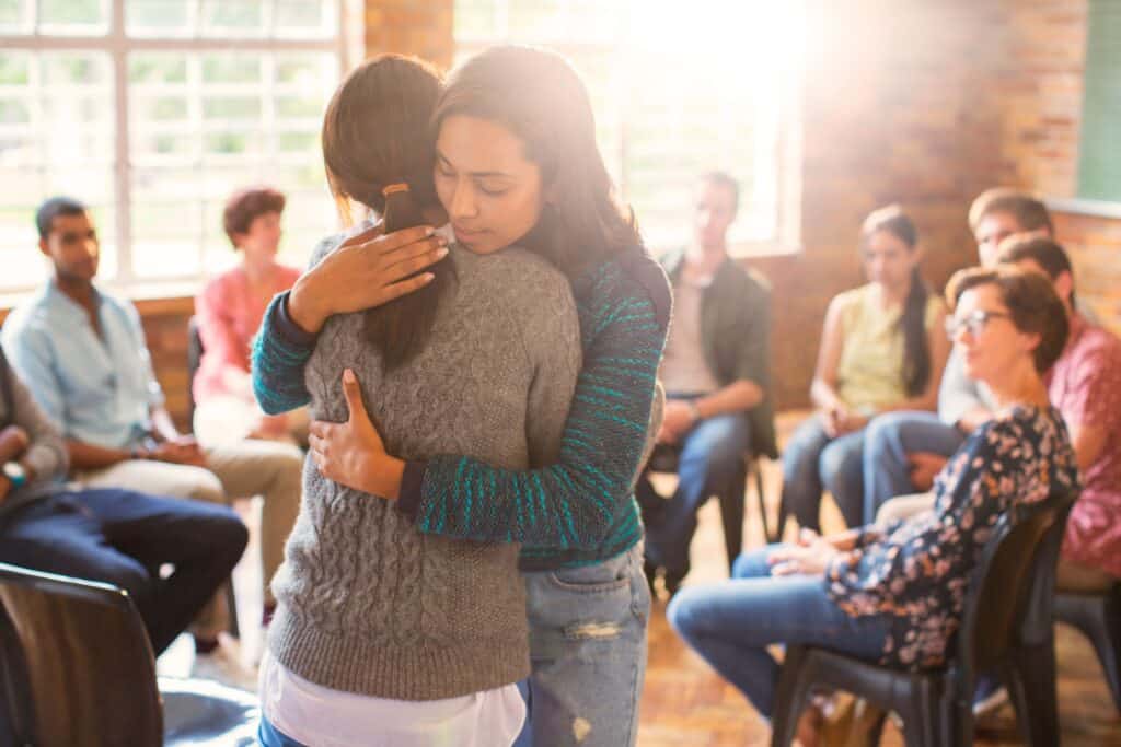 A woman being supported at group therapy during dialectical behavior therapy in Nashville