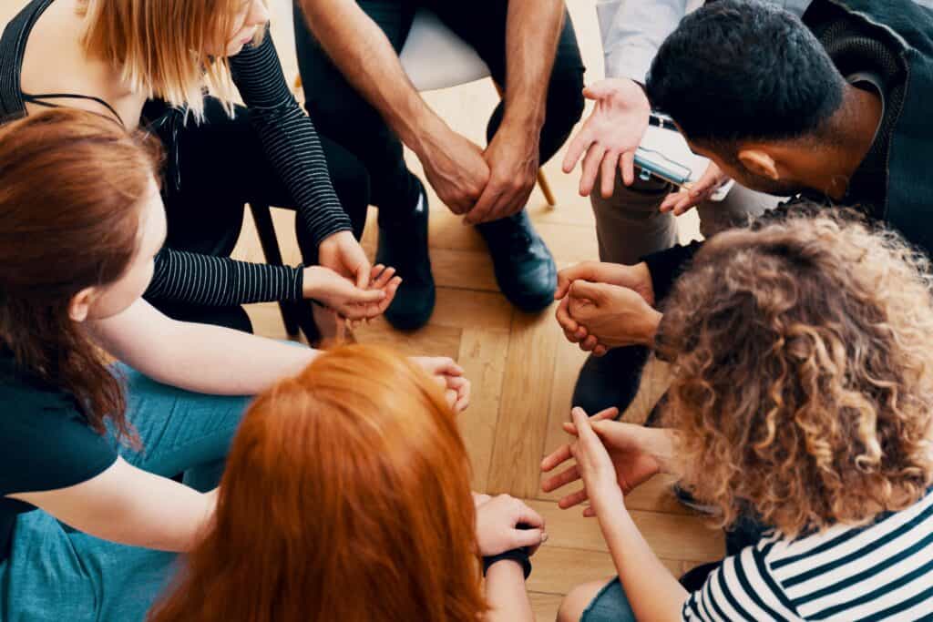 A large group exercise during group therapy in California 