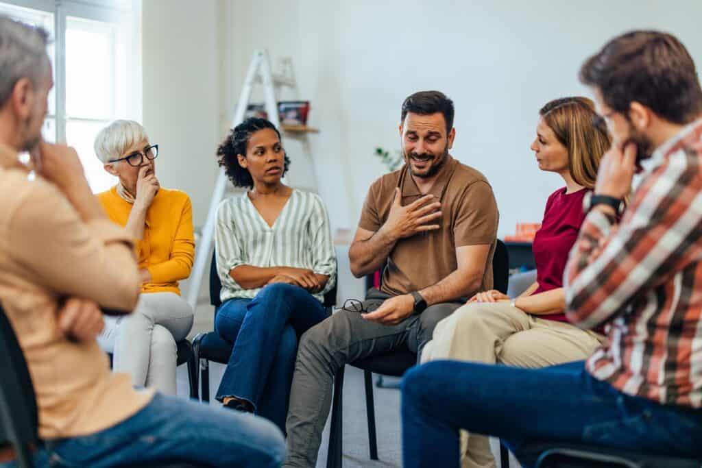 A man being supported at group therapy during dialectical behavior therapy in Nashville
